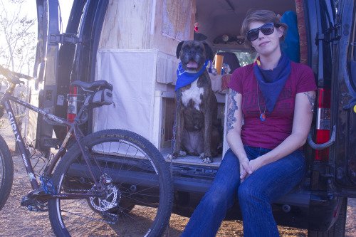 Casey Sheppard sits in back of van with dog